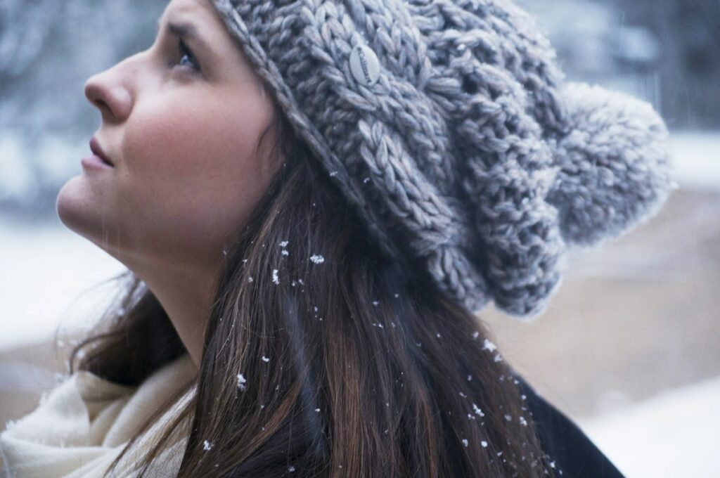Women wearing knit beanies outdoors in winter